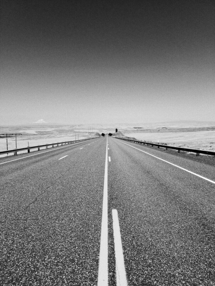 grayscale photo of concrete road
