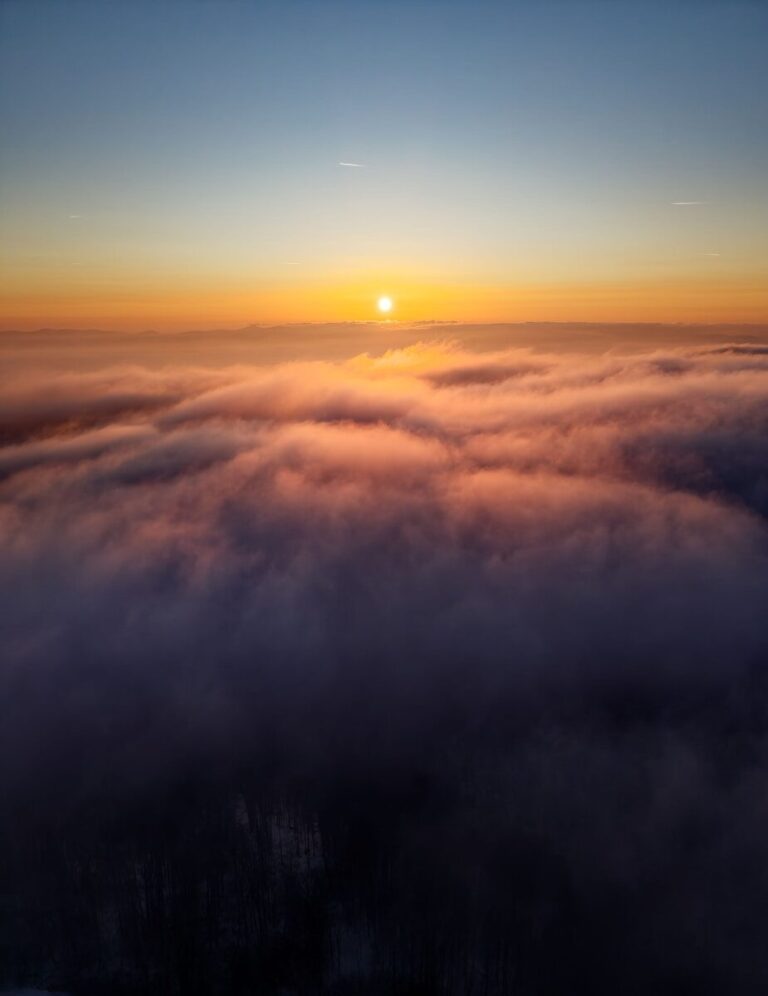 Sunrise over a sea of clouds with clear sky.