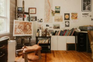 Creative artist&apos;s studio with easel, painting, and art supplies