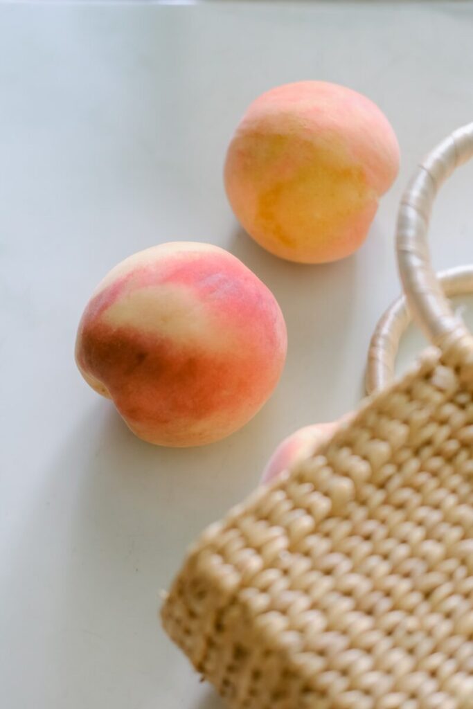 a few apples next to a mug